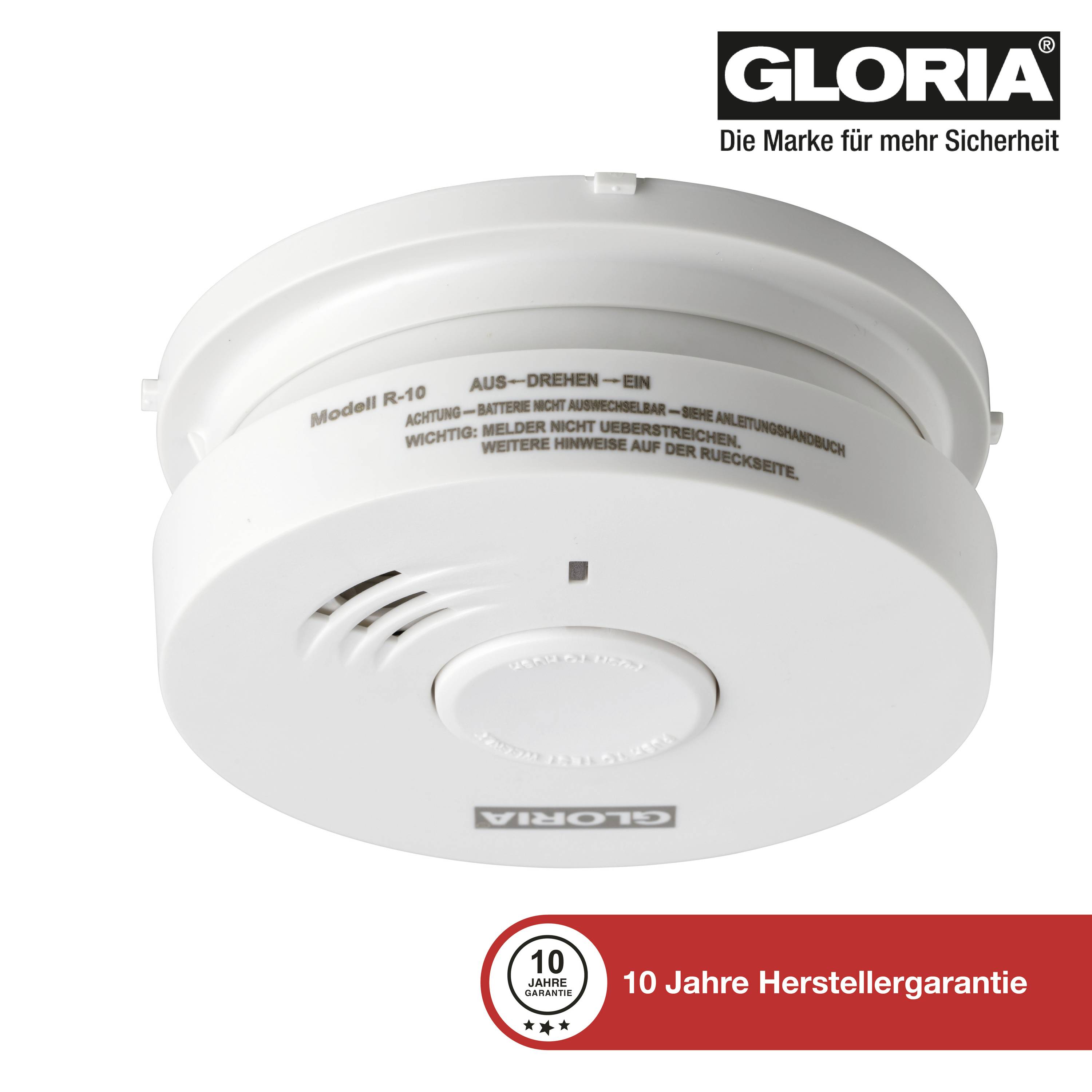 Rookmelder 'GLORIA' met 10 jaar fabrieksgarantie. Wit, rond apparaat met grote toets in het midden.