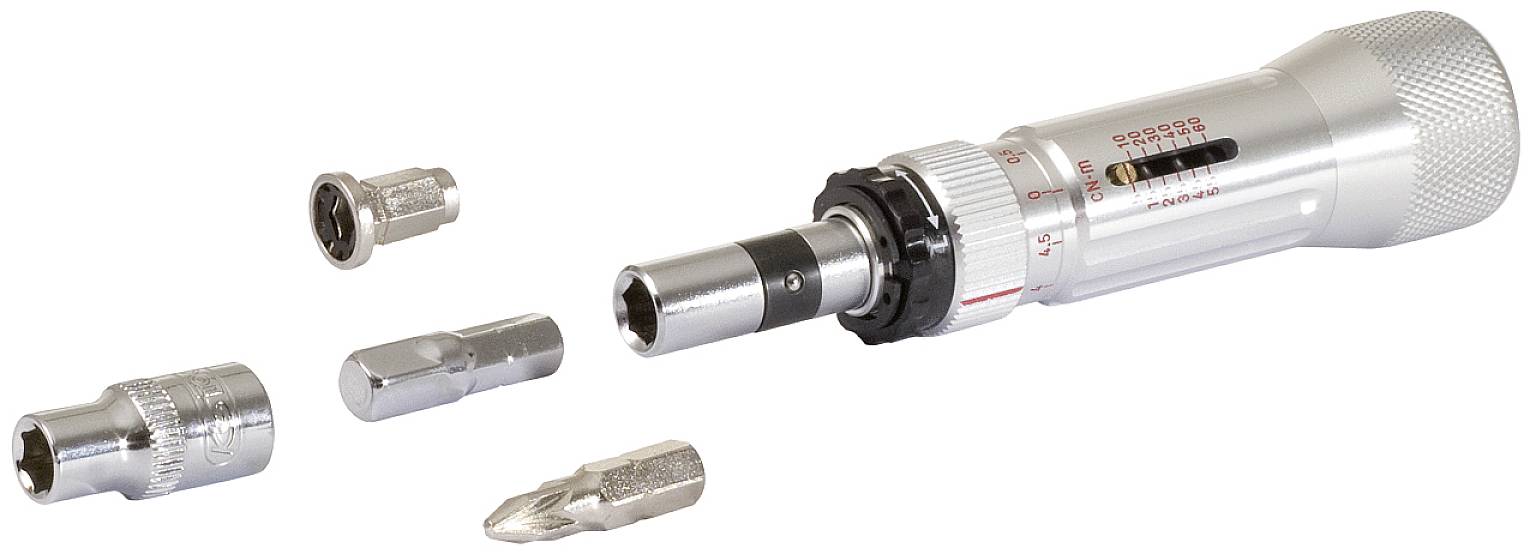 Momentsleutel met verschillende verwisselbare bits, liggend op een witte ondergrond.