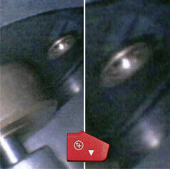 Close-upfoto van een lichtpunt door een vies raam. Een rode vergrootglas met een pijl wijst naar het object.
