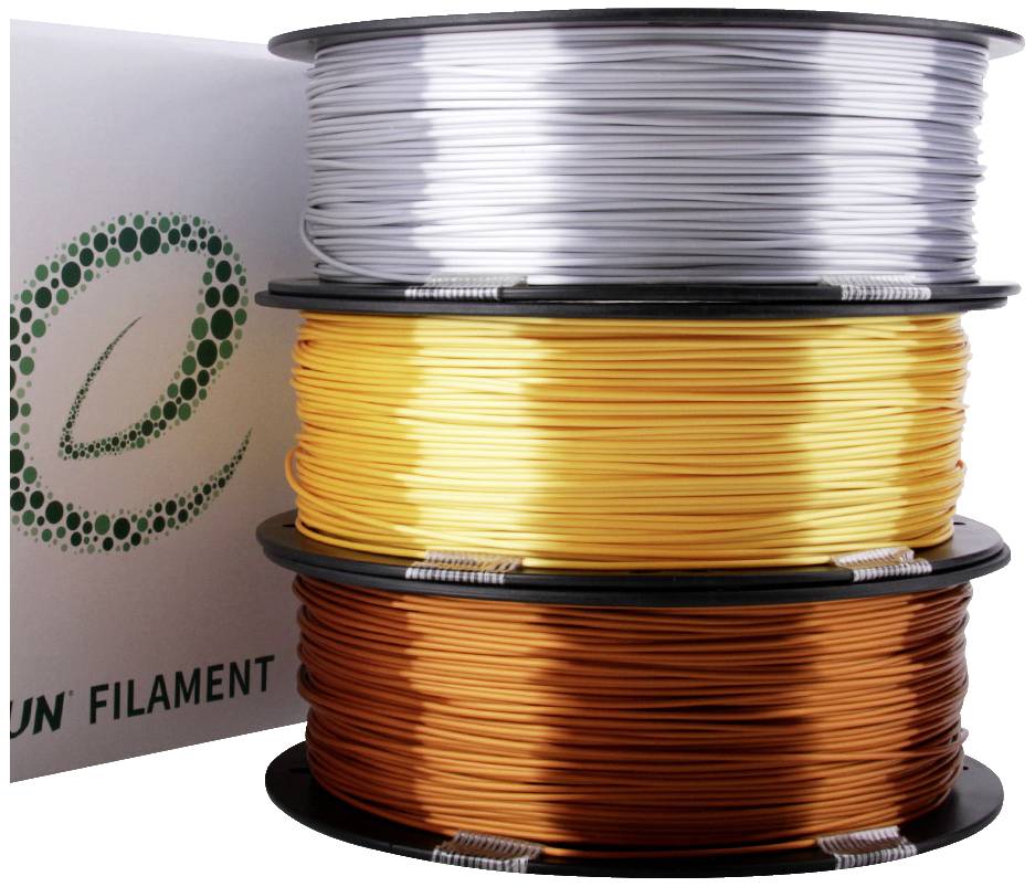 Drie rollen gekleurd filament liggen op elkaar: bovenaan zilver, in het midden goud en onderaan koper. Links staat een verpakking met logo.