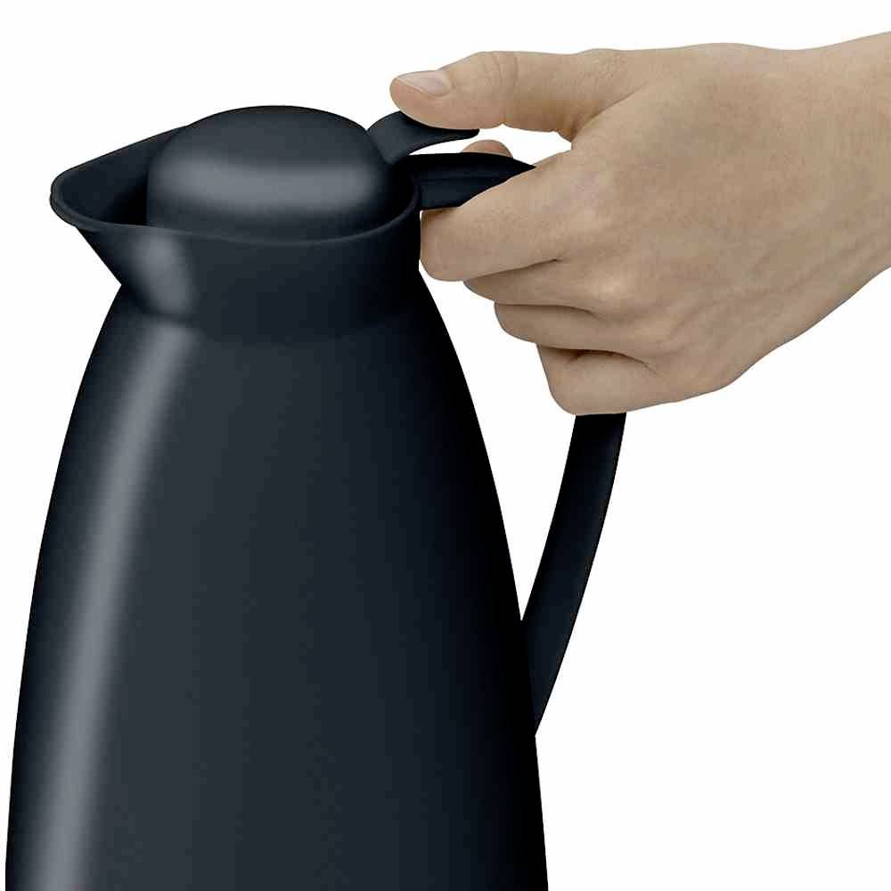 Een hand houdt een zwarte thermoskan vast bij het handvat. De deksel is stevig gesloten.
