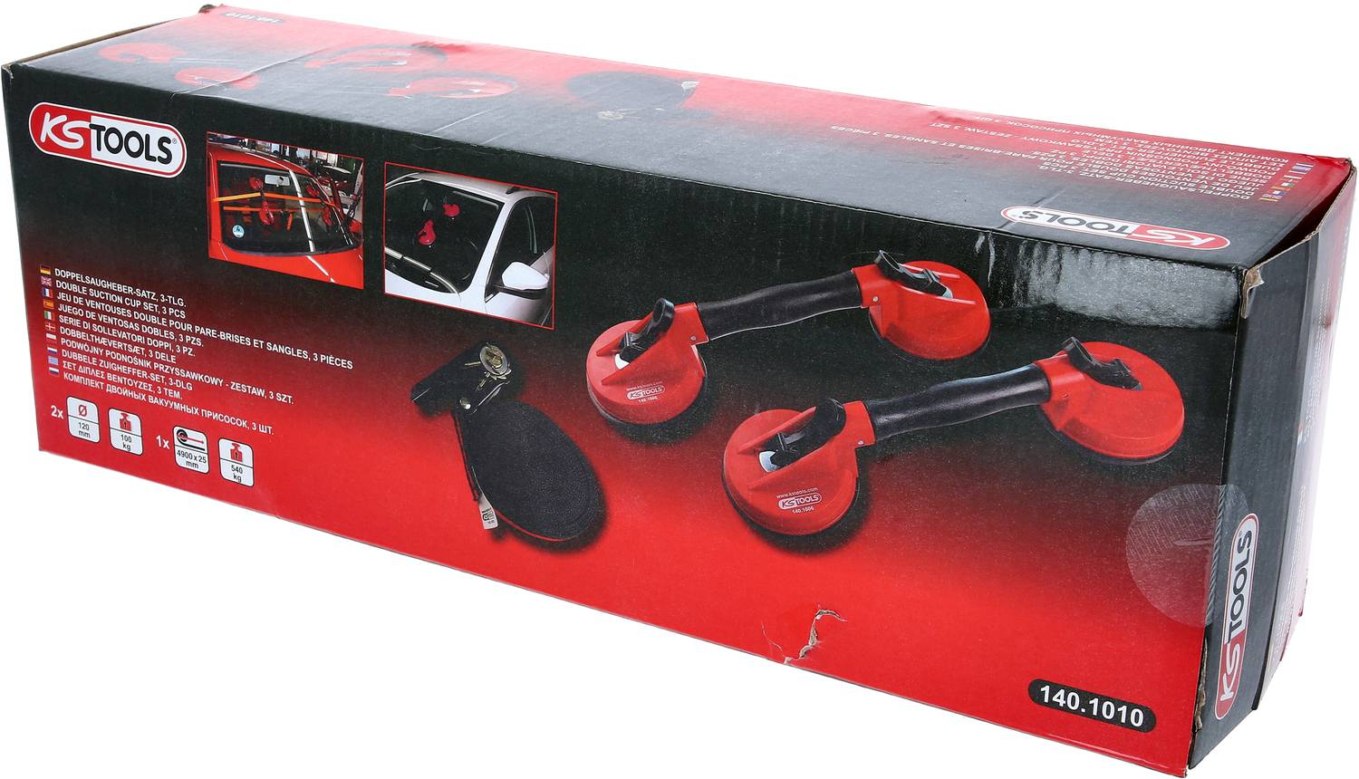 Verpakking van een KS Tools zuignap-set. Bevat drie rode zuignappen en toebehoren. Toepassingsvoorbeeld toont zuignap op een autoportier.