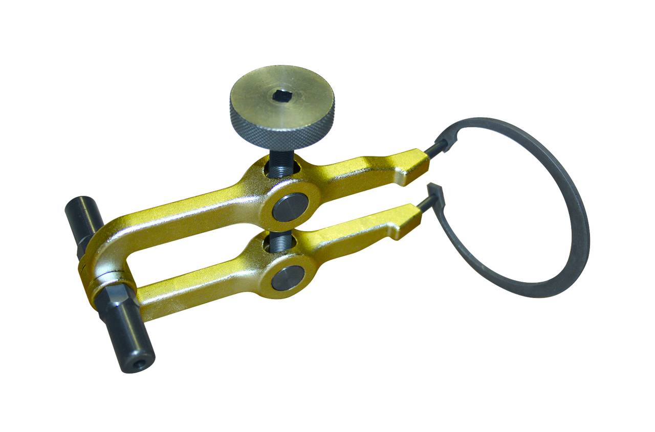 Een geel-gouden remklauw-aanpassingsgereedschap met een zwarte metalen ring op een witte achtergrond.