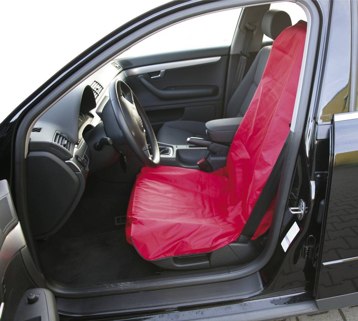 Een auto met een open bestuurdersstoel; de stoel is bedekt met een rode beschermhoes.