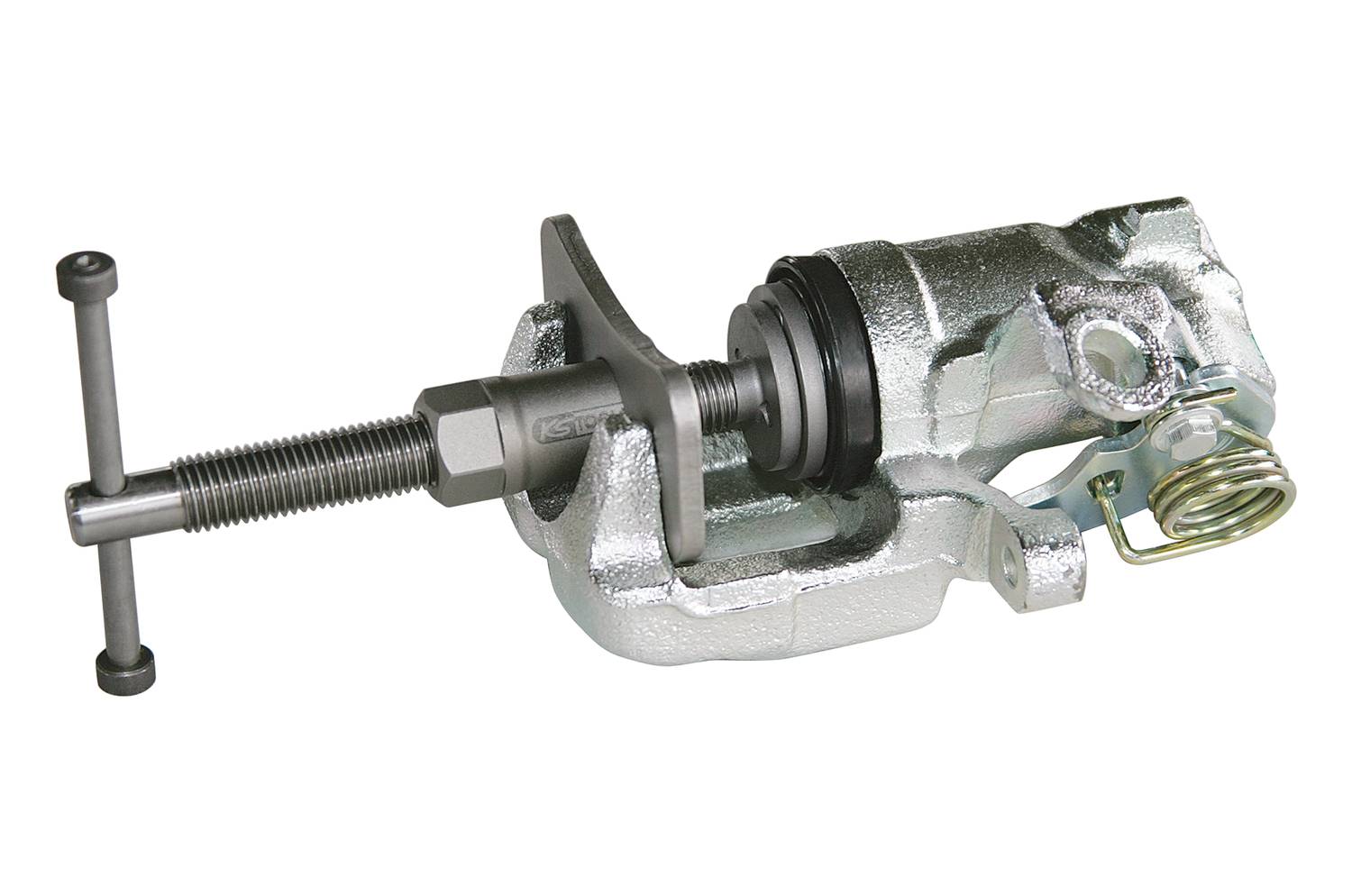 Een zilveren remklauw met geïntegreerd mechanisme en veer, waarschijnlijk onderdeel van een voertuig of machinebouw.