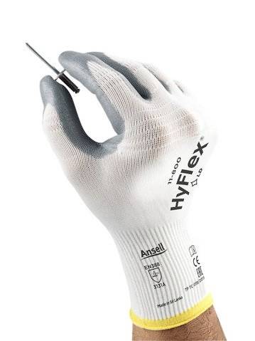 Hand met een witte werkhandschoen houdt een kleine schroef vast. De handschoen is van het merk HyFlex en biedt bescherming en flexibiliteit.