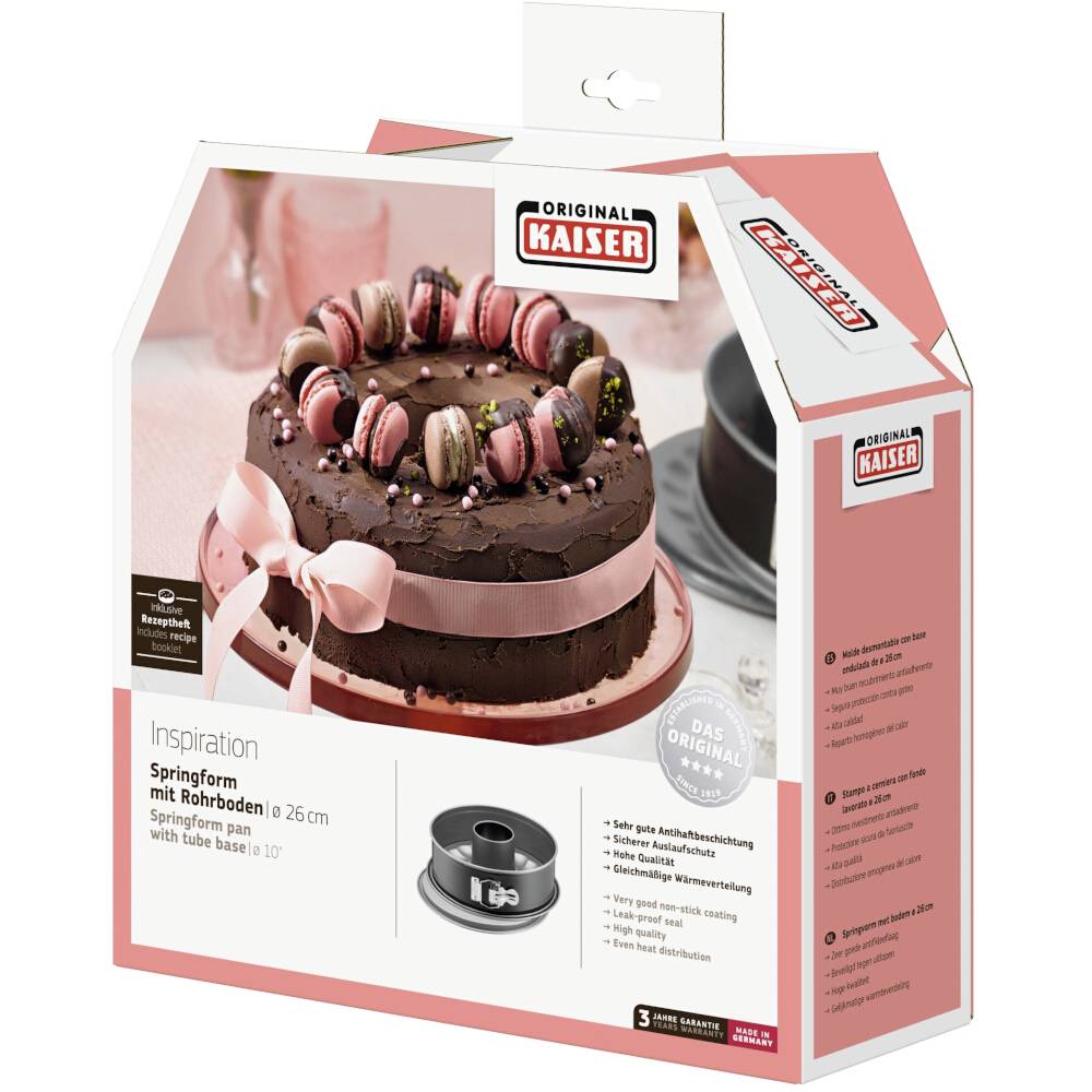 Verpakking van een 'Kaiser Inspiration' springvorm (26 cm) met een afgebeelde chocoladetaart, versierd met macarons en een roze strik op het deksel.