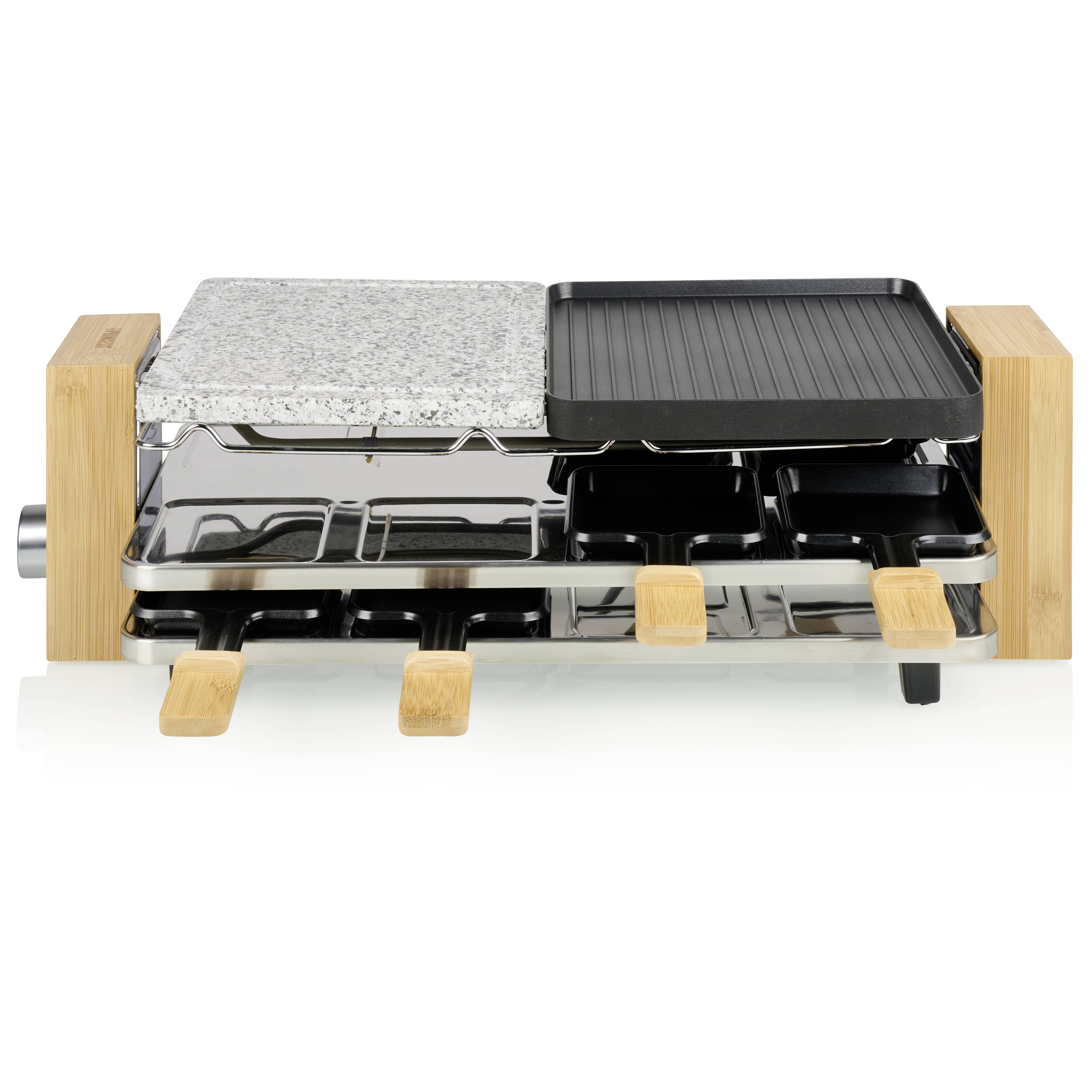 Een tafelgrill met twee grillplaten: één van steen en één gegolfde metalen plaat. Daaronder bevinden zich kleine pannetjes.