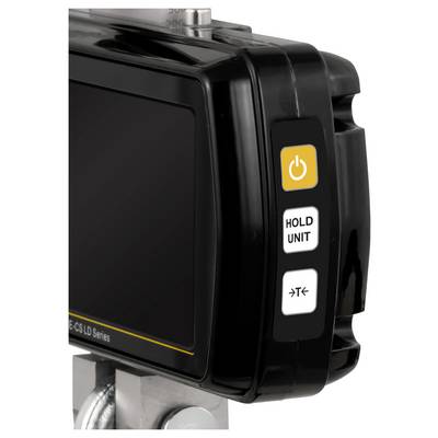 Close-up van een zwarte elektronische display-eenheid met drie zijknoppen, waaronder een gele aan-uitknop met het label 'HOLD UNIT' en een pictogramknop.