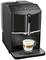 Een zwarte koffiemachine met een glazen kopje eronder, gevuld met een cappuccino. De machine toont bedieningselementen en een melkachtige schuimlaag.