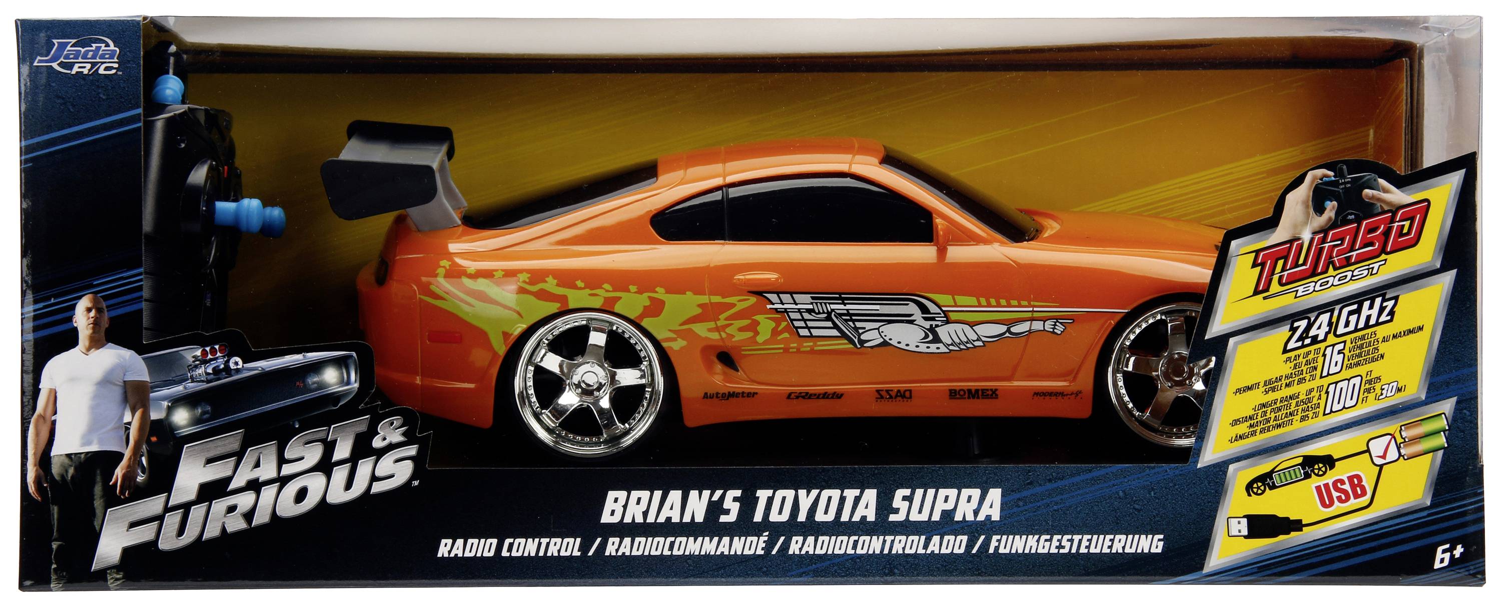 Een speelgoedverpakking toont een bestuurbare modelauto van 'Brian's Toyota Supra' uit 'Fast & Furious', in oranje met vlammen.