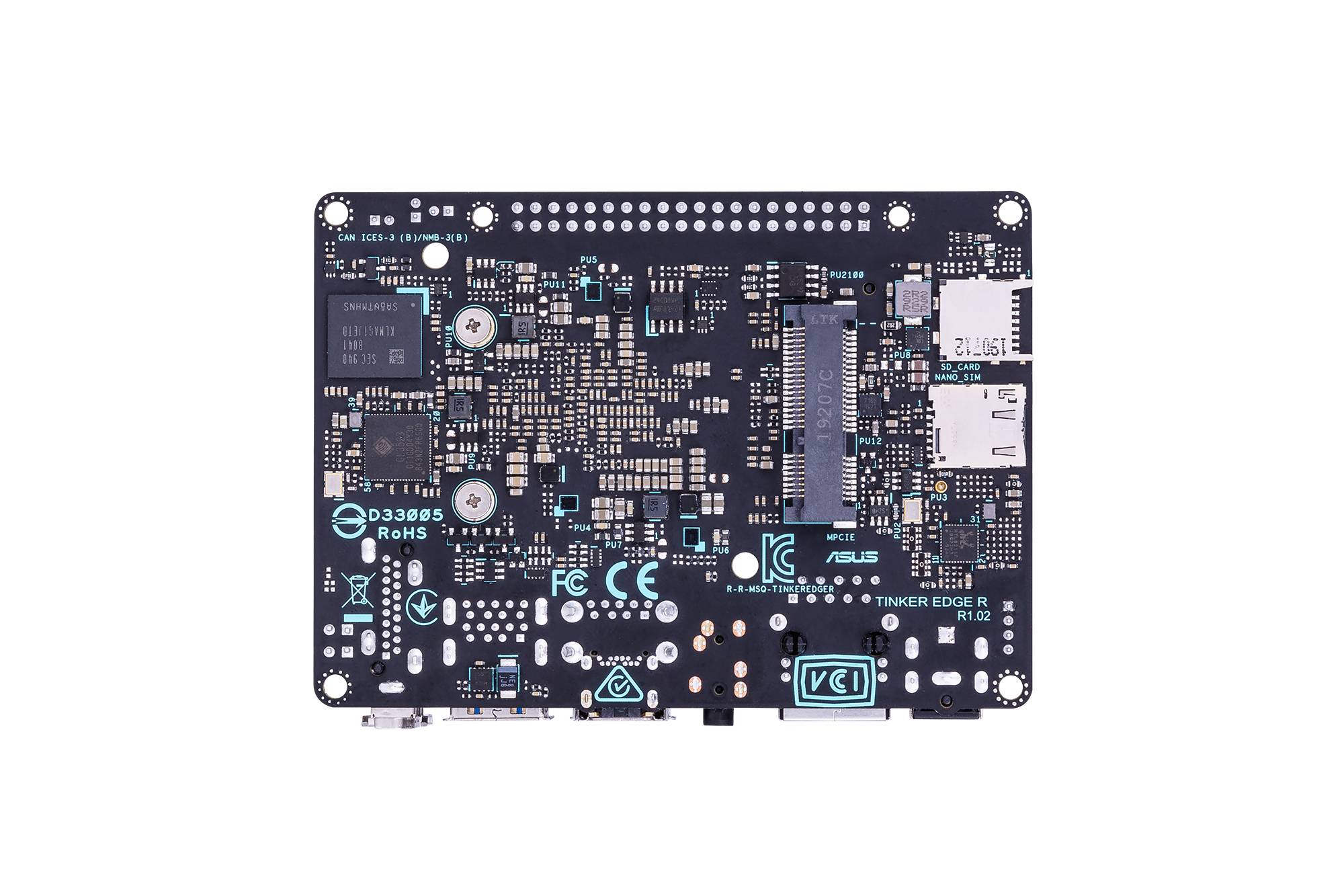 Een printplaat met verschillende elektronische componenten, waaronder chips, weerstanden en aansluitingen. Tekstmarkeringen en symbolen zichtbaar.
