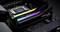 Twee RAM-modules op een moederbord, verlicht in regenboogkleuren. De modules zijn van een merk met de naam 'Trident Z5'.