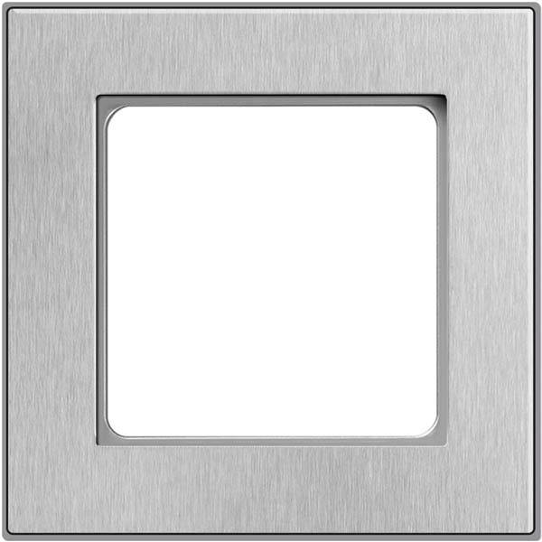 Grijze, vierkante wisselschakelaar-afdekplaat met een metaalachtige oppervlakte en een witte binnenkant. Minimalistisch design.