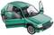 Een groen modelauto van de Peugeot 205 met geopende deuren. Zicht op het interieur met stoelen en stuurwiel. De auto staat stilstaand.