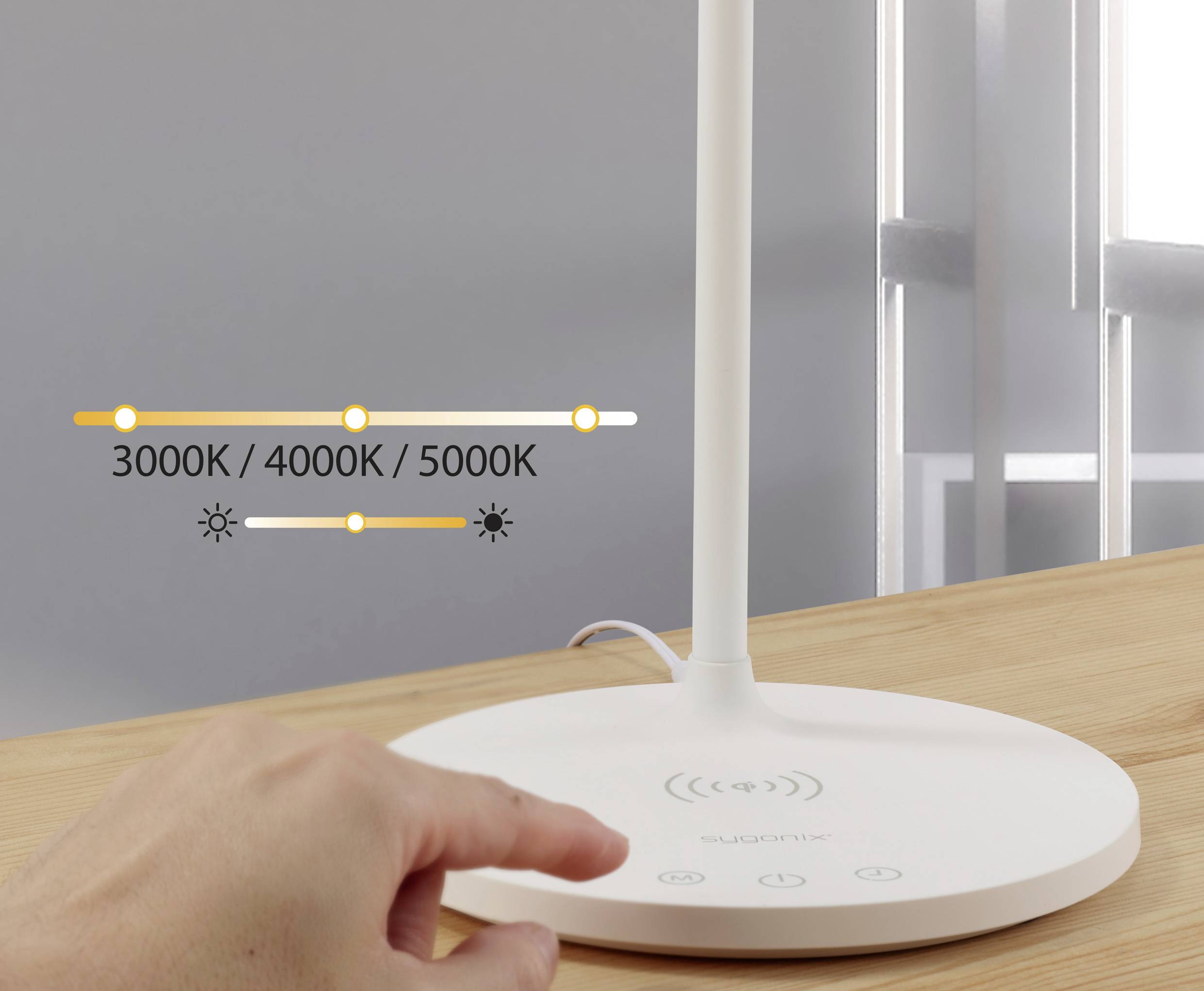 Een hand raakt de basis aan van een tafellamp met een touch-paneel dat lichttemperaturen van 3000K, 4000K en 5000K weergeeft.