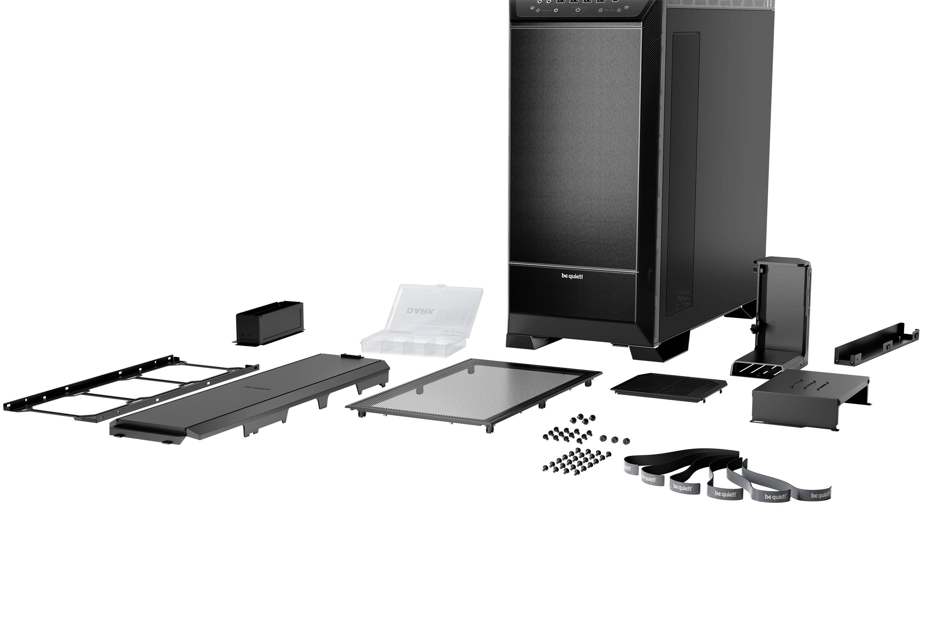 Een gedemonteerd computerbehuizing met alle afzonderlijke onderdelen, inclusief zijpanelen, schroeven, kabelbinders en stoffilters, gepresenteerd.