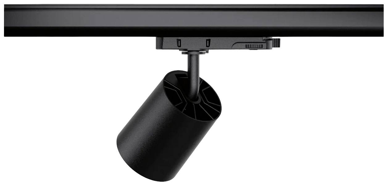 Een zwarte railspot hangt aan een rail. Hij is cilindrisch en straalt naar beneden.