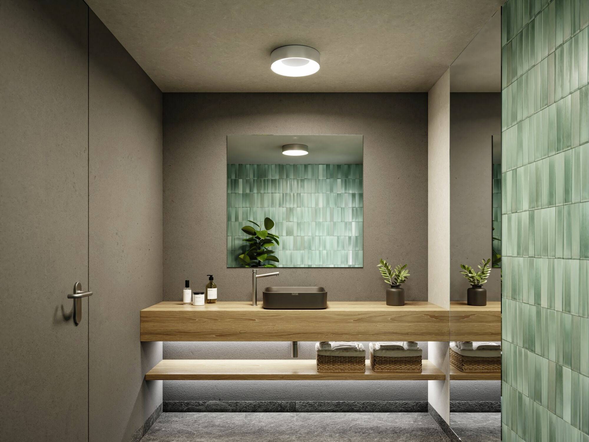Modern badkamer met houten wastafelblad, spiegel, wastafel en groene tegels. Planten sieren de plank.