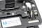 Close-up of a fiber optic cutter with a scale and instruction label 'The blade is to your side before setting a fiber!' in English.