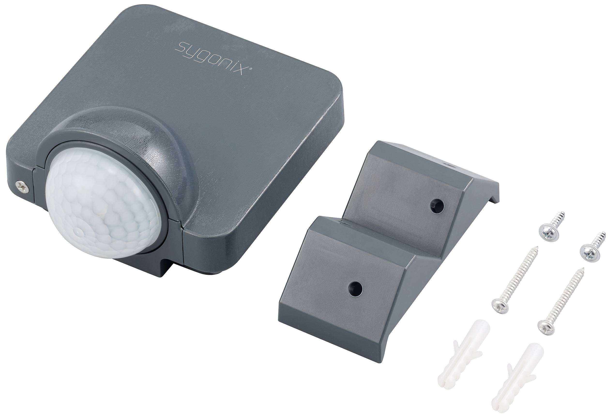 Bewegingsmelder in donkere behuizing met montagemateriaal: twee steunen, twee schroeven en pluggen.