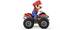 Een speelgoedfiguurtje in een rode hoed en blauwe overall rijdt op een klein rood quad met grote banden.