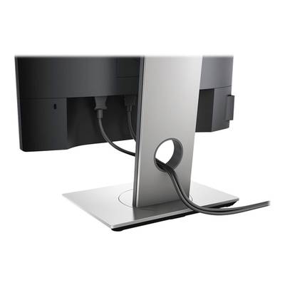 Een zwarte monitor van achteren met twee aangesloten kabels die door een opening in de zilveren voet worden geleid.