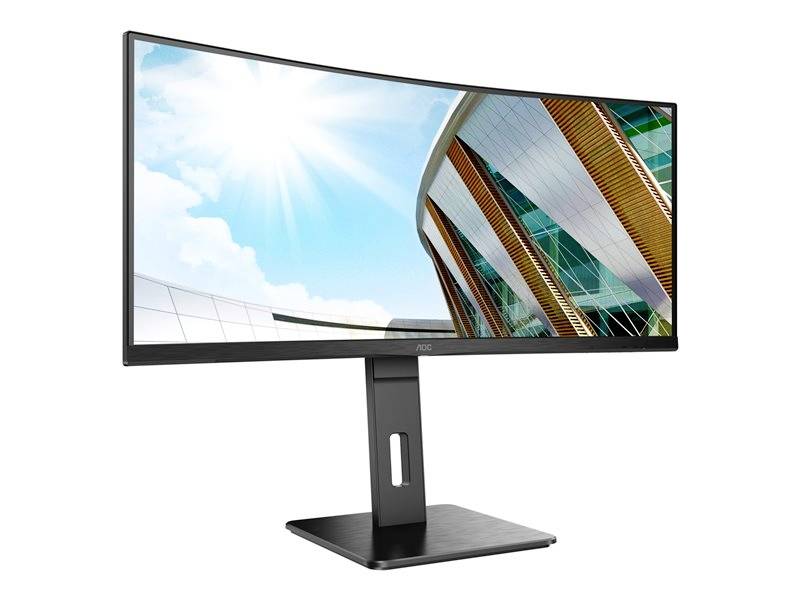 Een gebogen computermonitor toont een foto van een modern gebouw onder een blauwe lucht met zon.