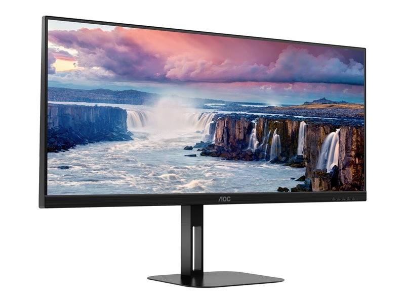 Een brede monitor toont een afbeelding met indrukwekkende watervallen onder een kleurrijke lucht.