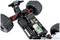 Een op afstand bestuurd auto-chassis met blootgelegde batterij, motor en schokdempers, toont technische details en constructie.