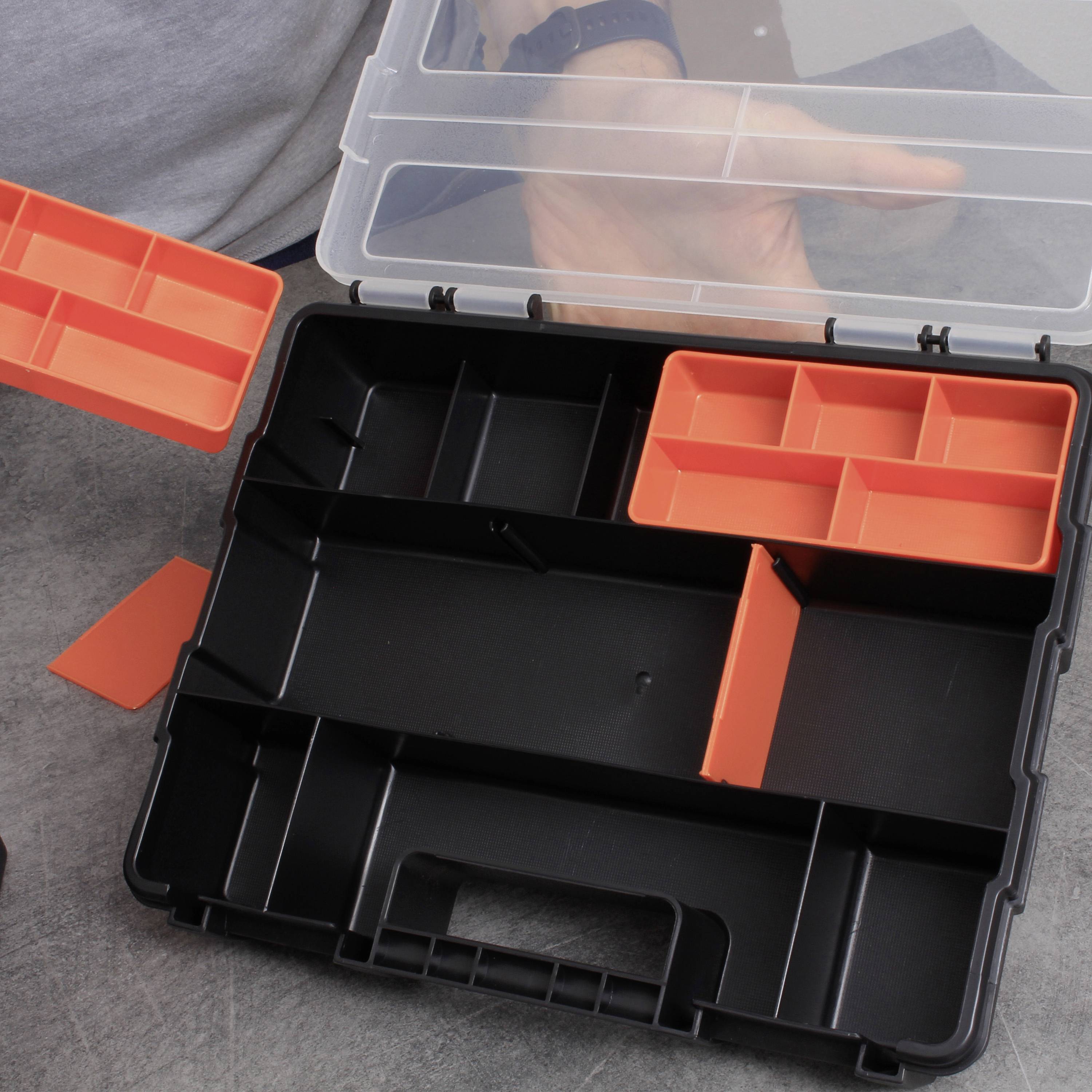 Open gereedschapskoffer met uitneembare, rode vakken. Één persoon houdt een vakdeksel vast, de deksel van de koffer staat open.