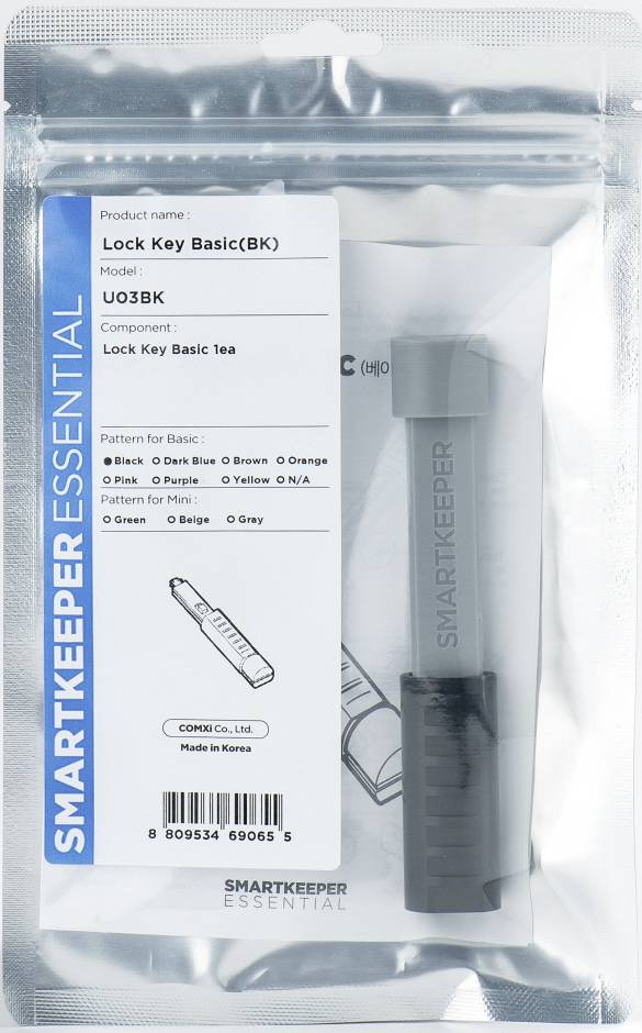 Een verpakking met een grijze 'Lock Key Basic' van Smartkeeper Essential. Productdetails en land van herkomst zijn zichtbaar.