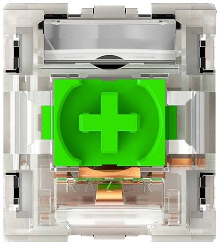 Transparante mechanische toetsschakelaar met groene kruisvormige middensectie, omgeven door heldere kunststof onderdelen en metalen componenten.