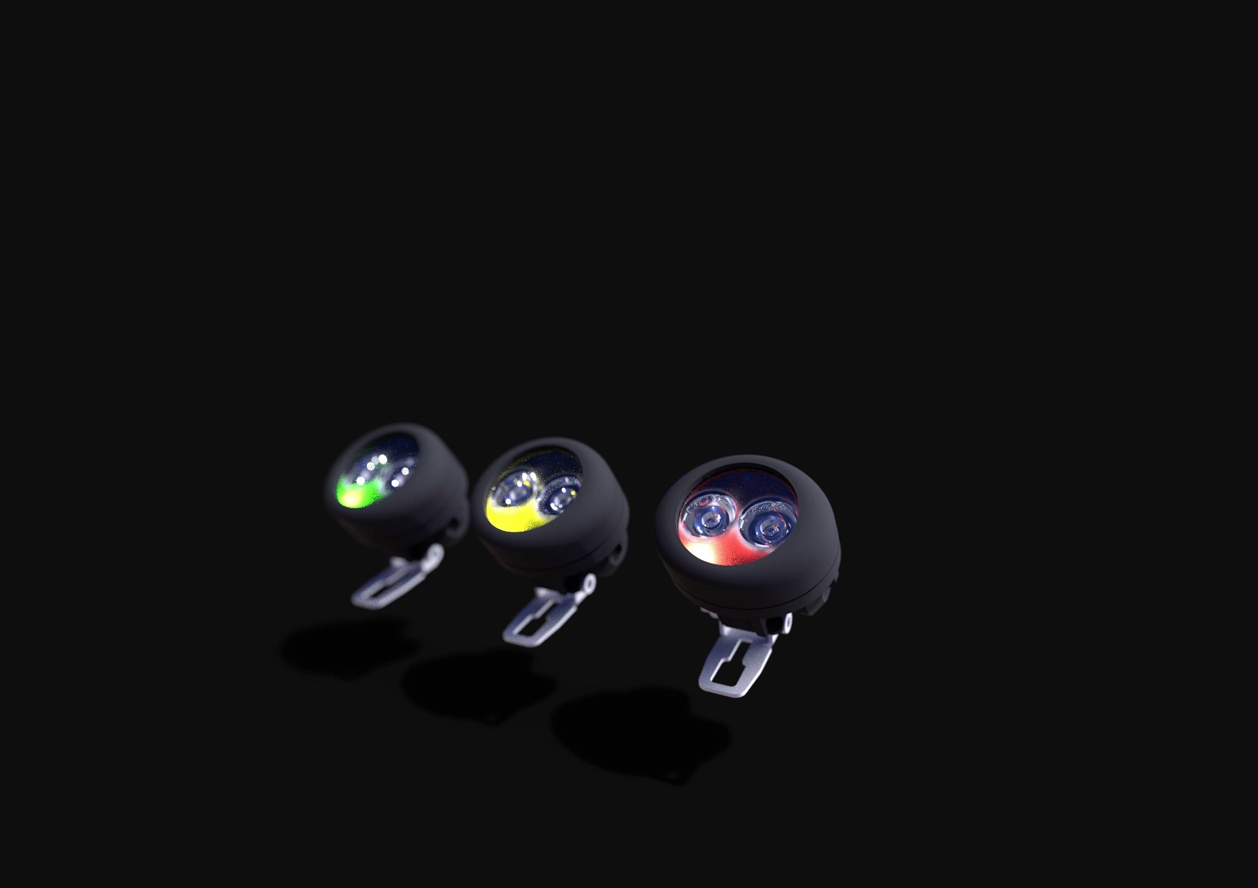 Drie ronde lampen naast elkaar op een zwarte achtergrond: links groen, midden geel, rechts rood brandend, elk met twee LED's.