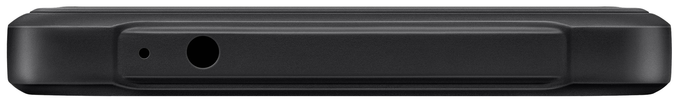 Een zwarte smartphone ligt plat, met de bovenkant zichtbaar waarop de koptelefoonaansluiting en microfoonopening te zien zijn.