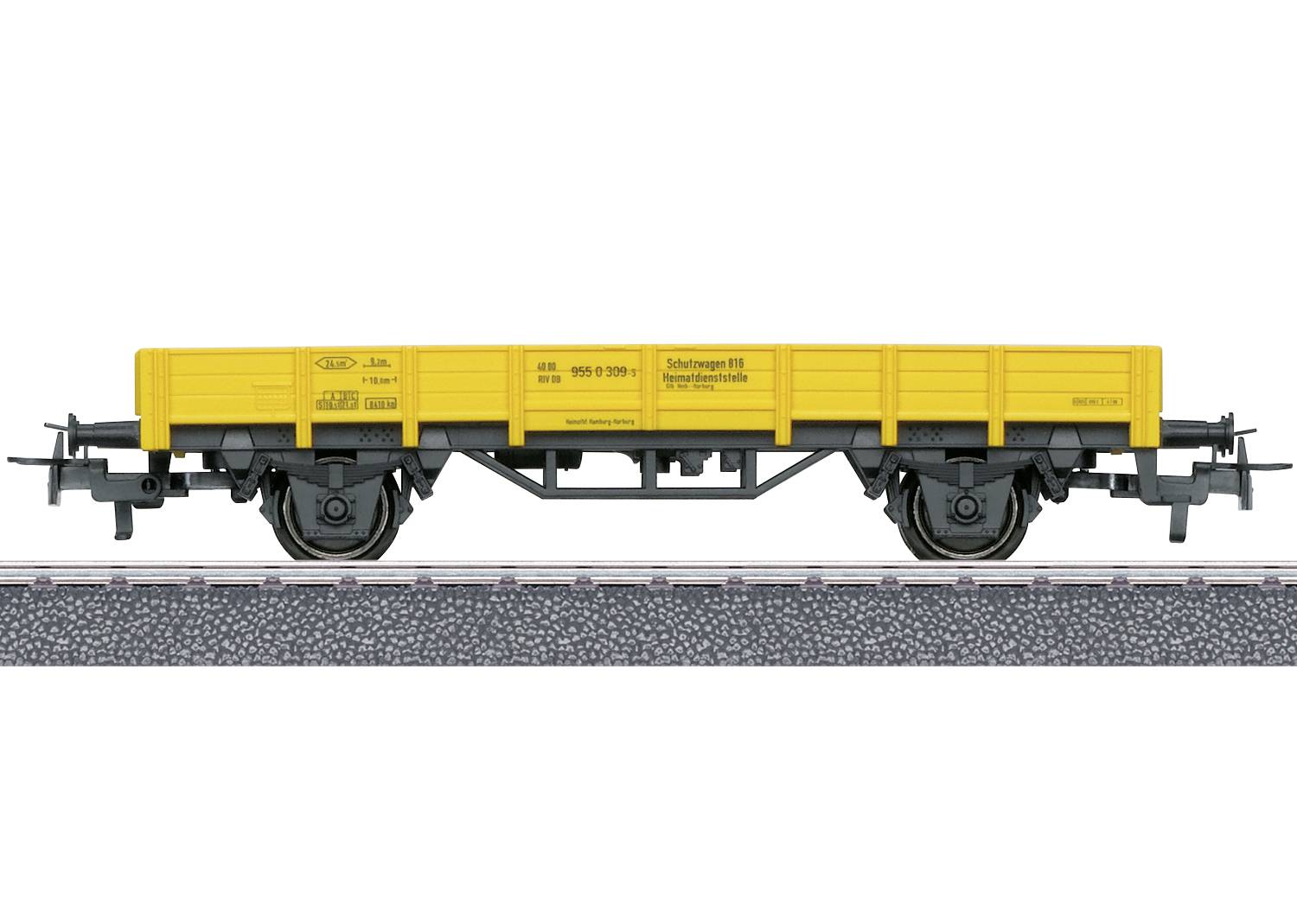 Geel goederenwagen-model op spoor, zijaanzicht.