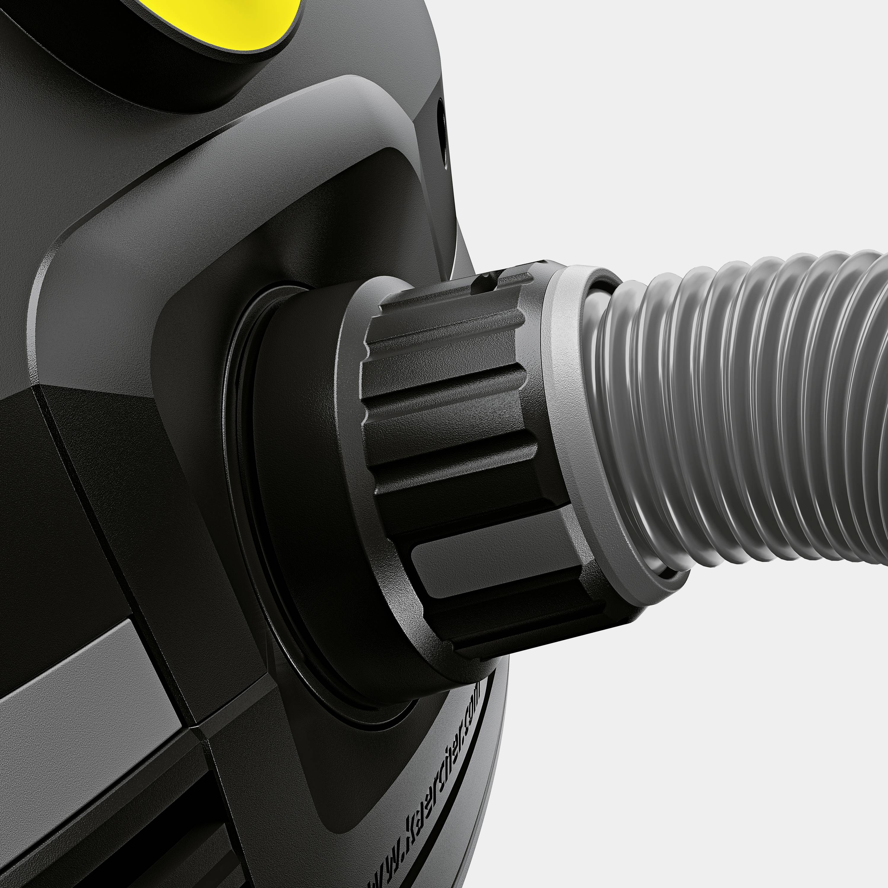 Close-up van een stofzuiger die de aanzuigslang toont. De slang is stevig bevestigd aan de behuizing.