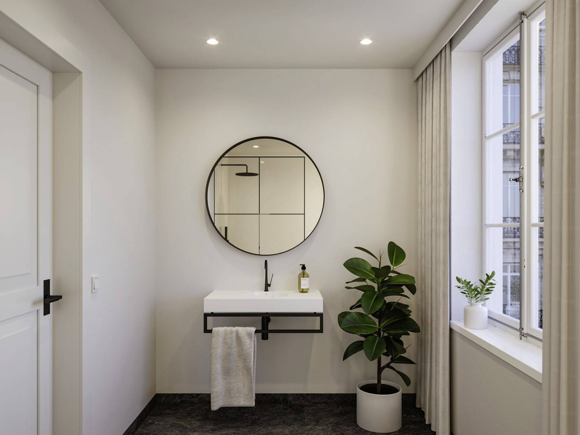 Een modern badkamer met een ronde spiegel, wastafel en handdoek. Naast de wastafel staat een groene plant op de vloer.