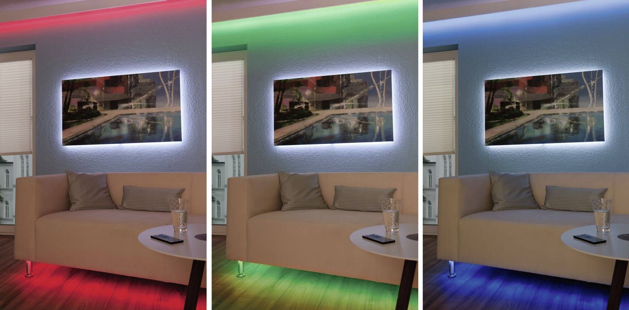 Een woonkamer toont een bank, een tafel en een schilderij aan de muur, terwijl LED-verlichting bovenaan en onderaan rood, groen en blauw oplicht.