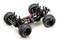 RC-auto-chassis met vier grote terreinbanden, zichtbare schokdempers en een bekabelde elektromotor.