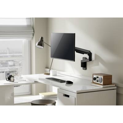 Een moderne, opgeruimde werkplek met een monitor aan een flexibele arm, een lamp, toetsenbord, muis en paperclips op een witte tafel.