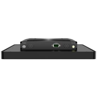 Een zwart elektronisch apparaat met aansluitingen aan de voorkant, waaronder een COM2-poort en WLAN-antenne, op een platte basis.