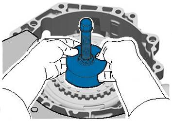 Handen die een blauw gereedschap vasthouden in een machinebehuizing. Het gereedschap is cilindrisch met een lange schroef in het midden.