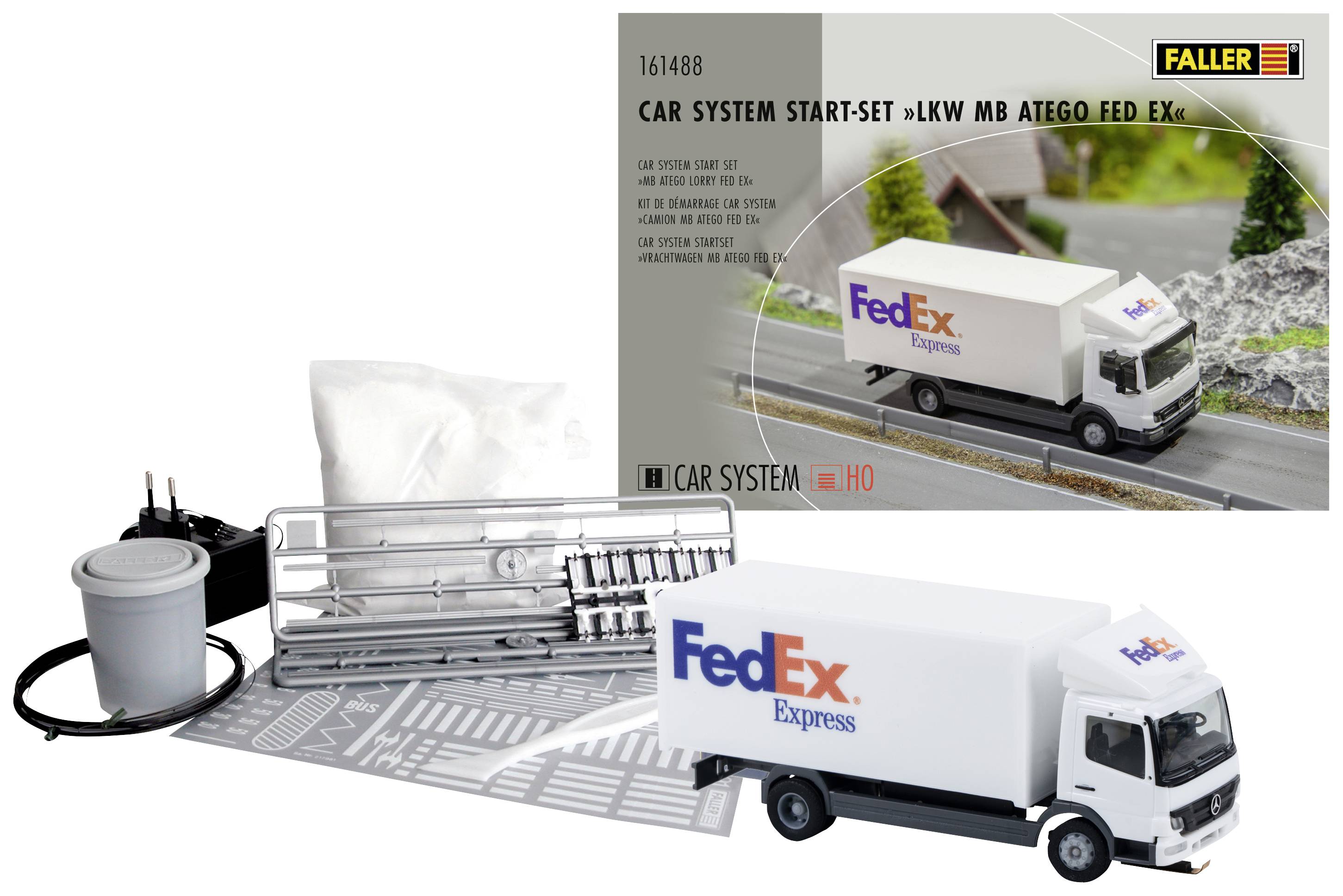 FedEx-vrachtwagen modelbouwset van Faller met handleiding en toebehoren, afgebeeld tegen een achtergrond die een straatscène voorstelt.