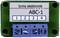 Elektronische module met opschrift 'tams elektronik ABC-1'. Vier genummerde aansluitingen eronder.