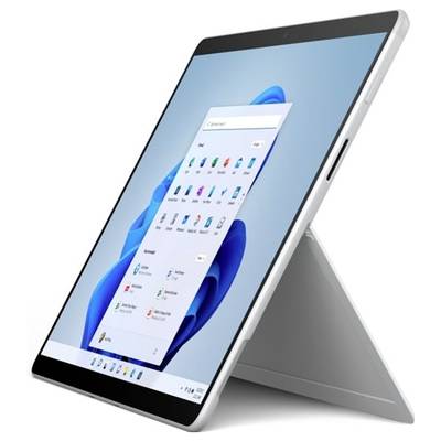 Een tablet op een standaard toont het Windows-startscherm met pictogrammen en een blauwe achtergrond.
