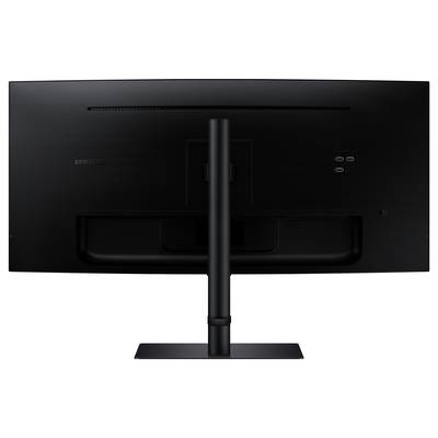 Een zwarte computermonitor van achteren, met een breed scherm en een stevige standaard. Twee USB-poorten zichtbaar.