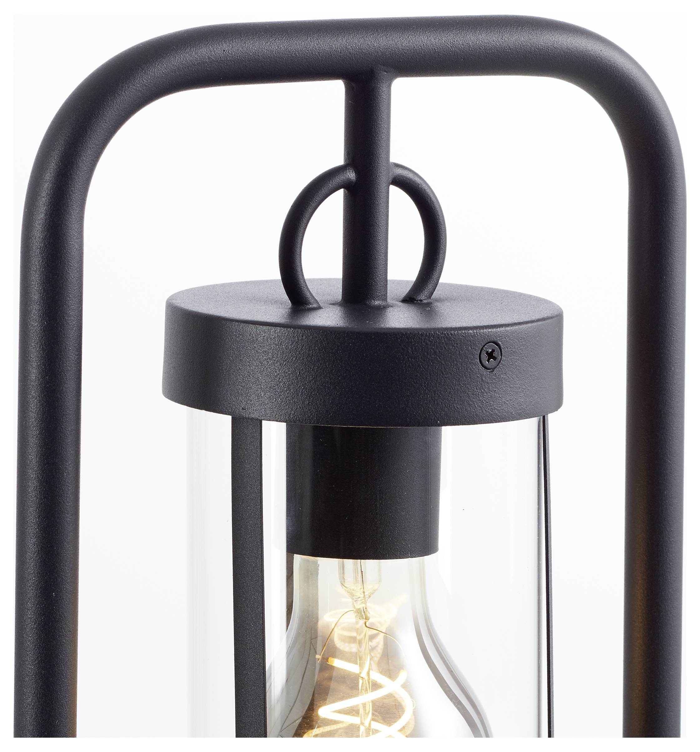 Zwarte metalen lantaarn met gloeilamp aan de binnenkant, modern design, cilindrisch glas, ideaal voor decoratie of verlichting binnenshuis.