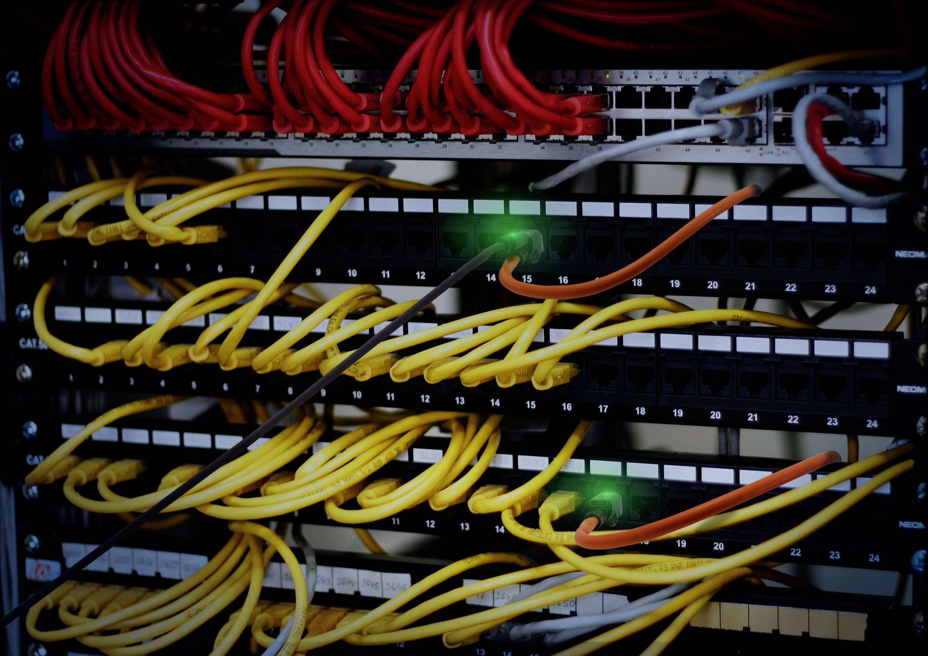 Een netwerk-serverrek met gele en rode kabels, aangesloten in een internet-datacenter.