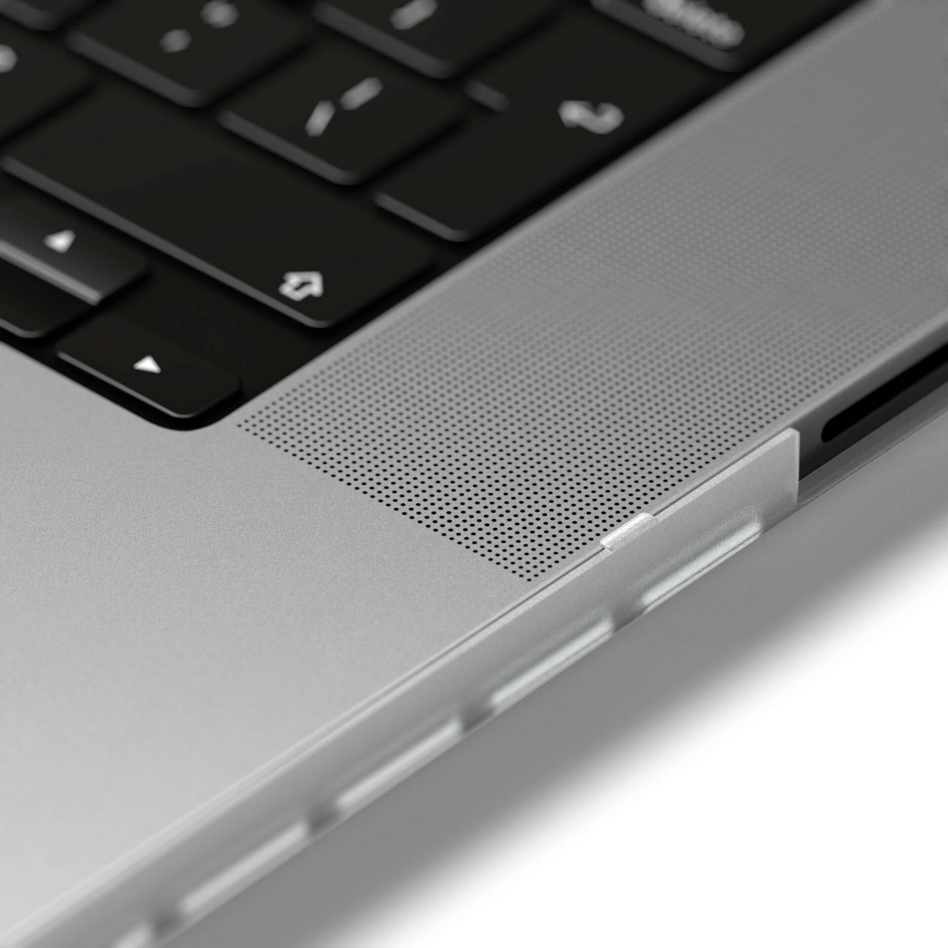 Close-up van een laptoptoetsenbord en een luidspreker in een elegant, modern design.